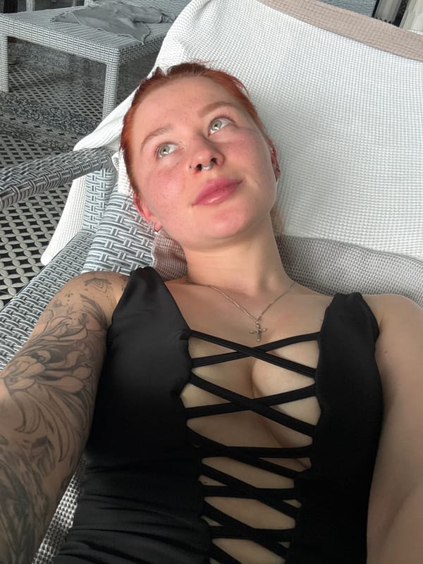 Red-haired woman photographed relaxing on outdoor furniture in Rostov-on-Don