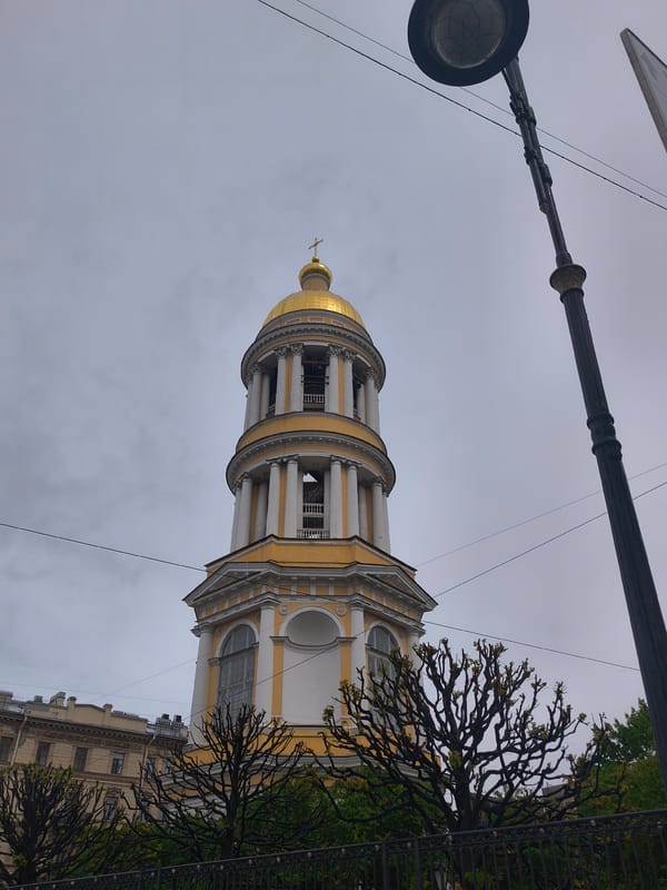 Ornate church with golden domes observed in street scene