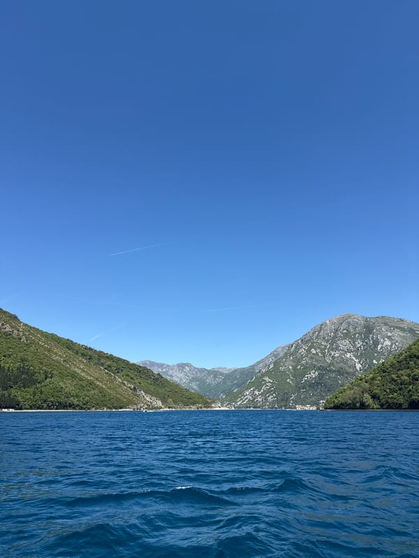 Boat travels scenic waters near Lepetane, Montenegro coastline
