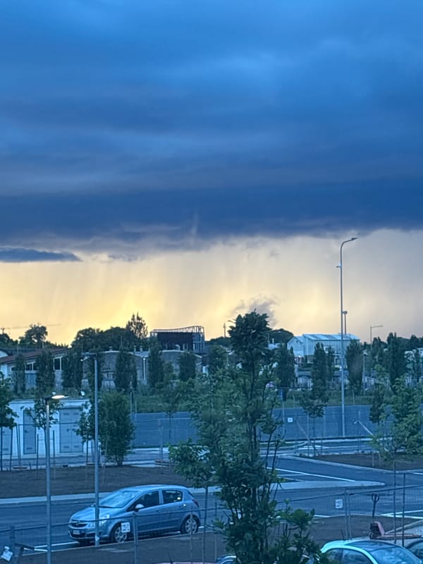 Dramatic storm clouds meet golden light over Novate Milanese