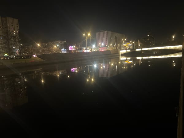 Night photography captures illuminated Saint Petersburg canals and moon