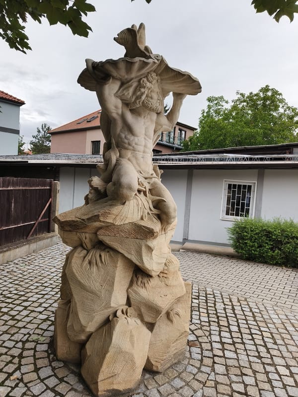 Ornate stonework and vintage furniture details in Prague