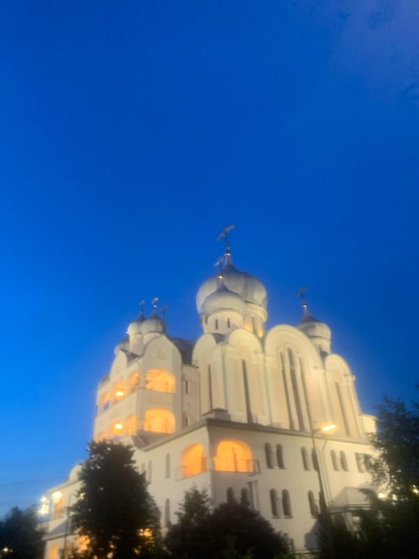 Evening scenes captured in Vsevolozhsk showing illuminated church, street activity