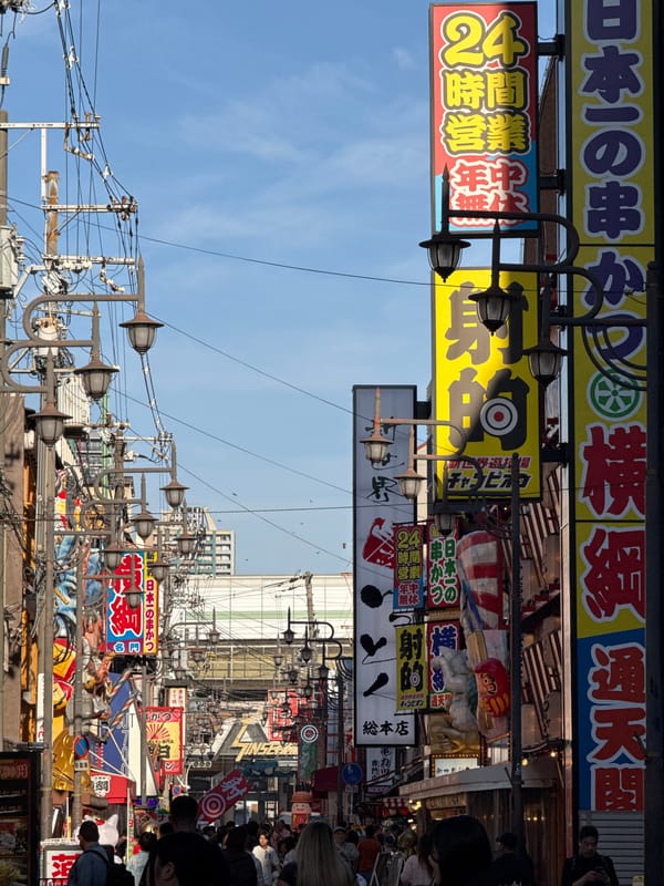 Tourist documents colorful Osaka streetscapes and landmarks during morning walk