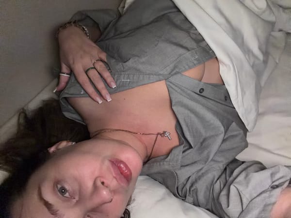 Person rests in bed wearing gray shirt in Moscow