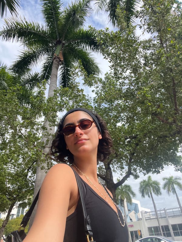 Woman takes selfies on Miami Beach sidewalk