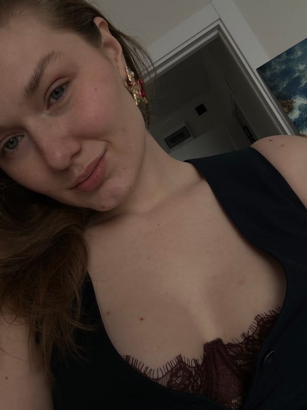 Woman takes multiple selfies indoors in Kazan