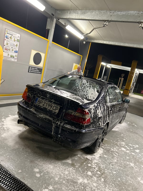 BMW sedan gets washed at self-service car wash