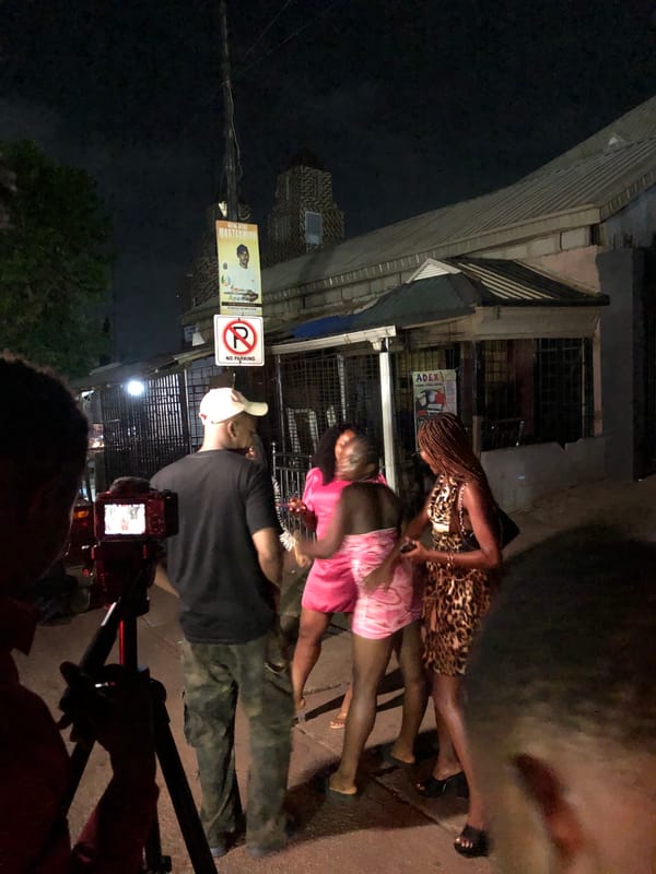 Four women filmed by camera crews on urban street