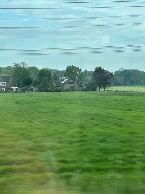 Train passenger views Dutch countryside near Loenersloot