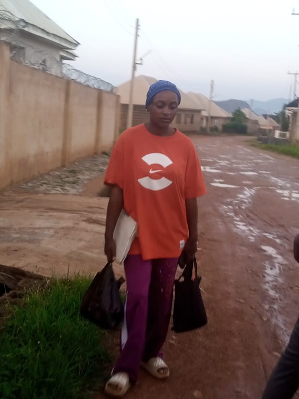 Everyday street scene on a wet road in Delimi, Nigeria