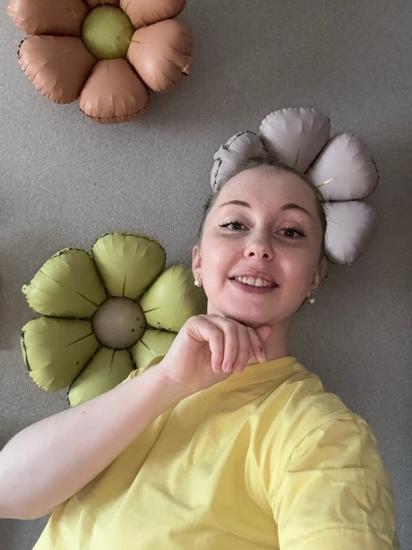 Woman poses with flower balloons during morning travel outing