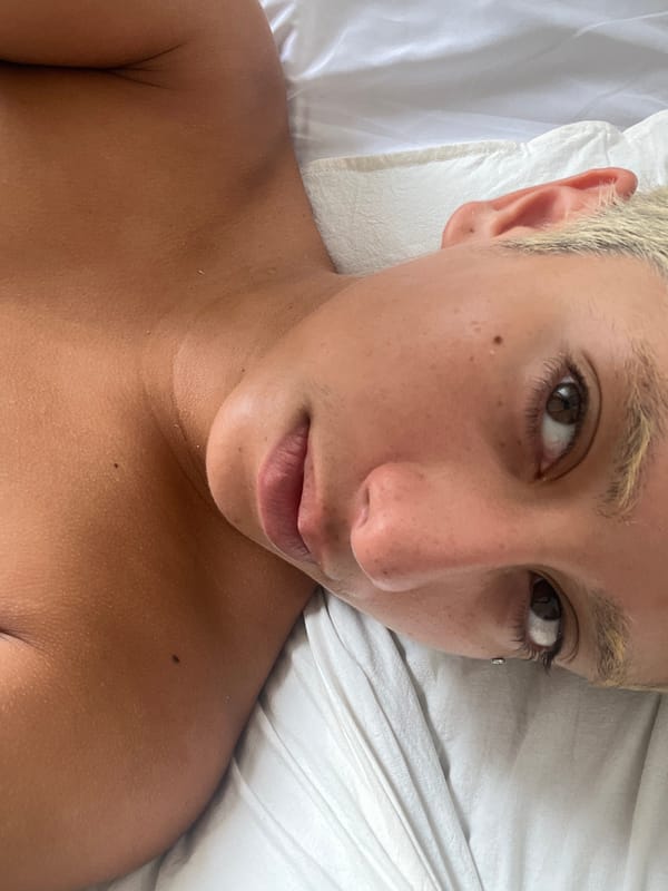 Person takes selfie while reclining on bed in Buenos Aires