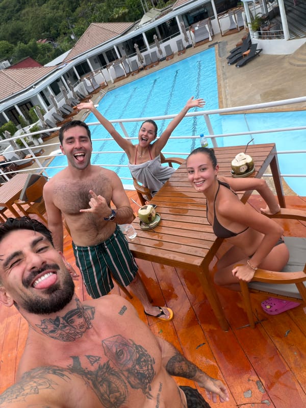 Four people take poolside selfie in Kathu, Thailand