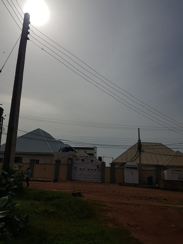 Morning street scenes across two Nigerian neighborhoods after rain