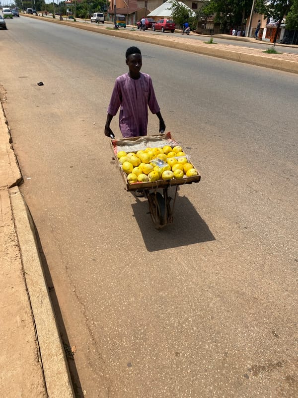 Street vendors and traders carry goods in Bukuru Nigeria