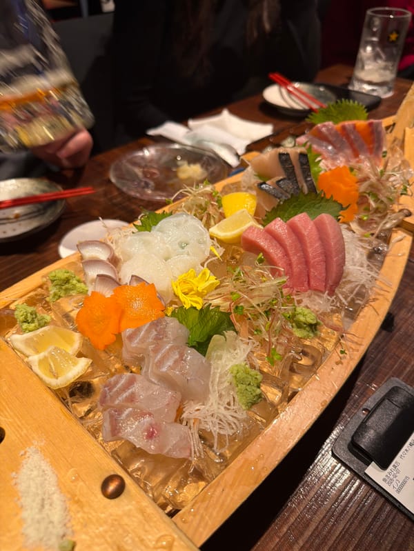 Chef serves sashimi boat platter to family in Shibuya restaurant