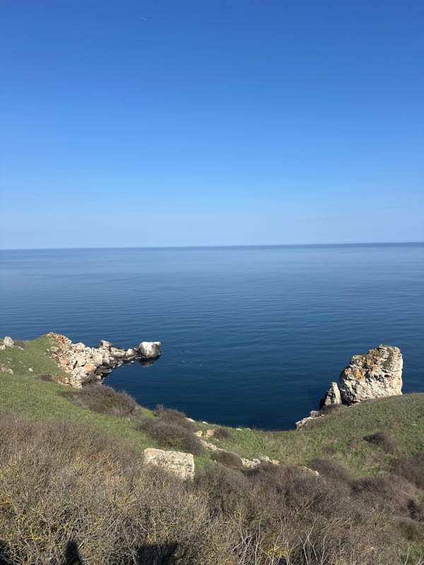 Visitor documents scenic Black Sea cliffs at Kamen Bryag