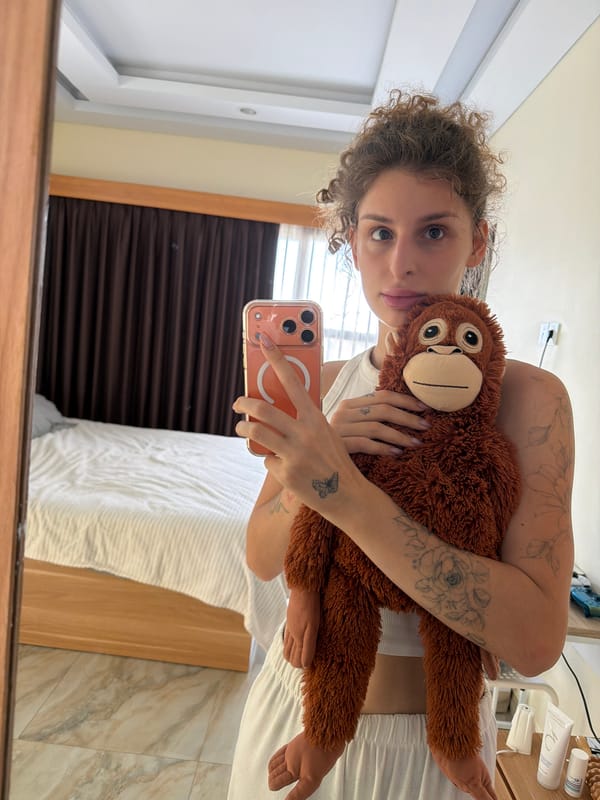Hotel room outfit shots in Bali with a stuffed orangutan