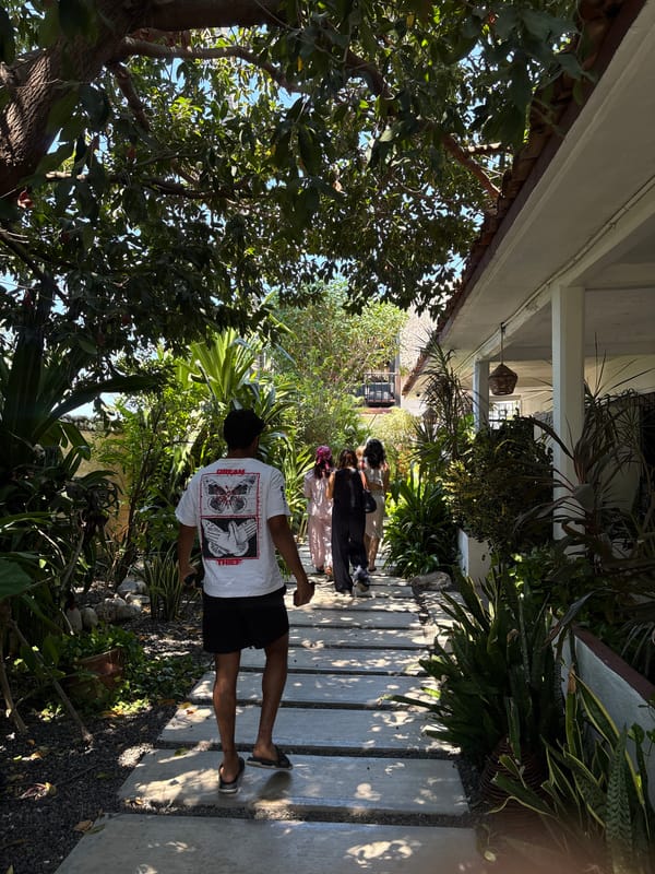 Visitors stroll through tropical garden pathway in Puerto Escondido