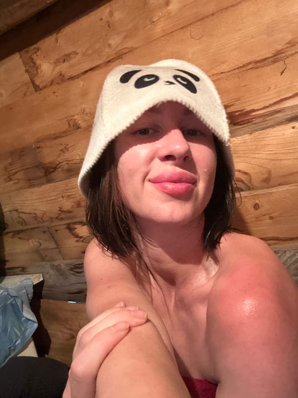 Woman rests near wooden structures in Votkinsk interior space