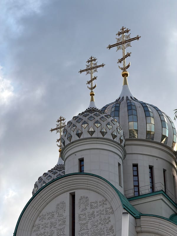 Orthodox church domes rise against a cloudy Moscow sky