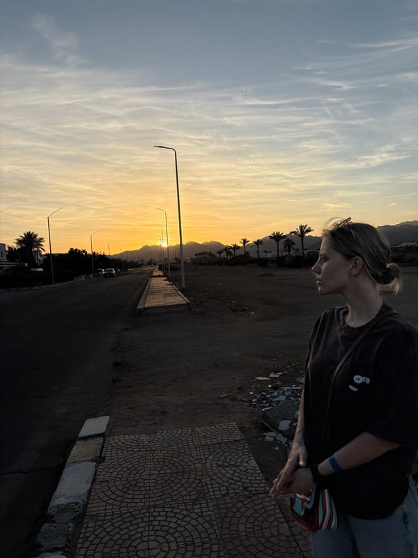 Tourists photograph sunset moments on Sharm El Sheikh street