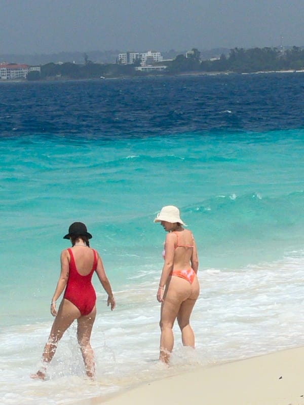 Beachgoers enjoy sunny morning activities on Zanzibar shores