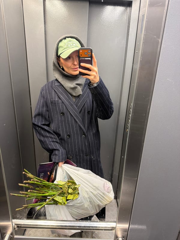 Person takes selfie in reflective surface in Moscow