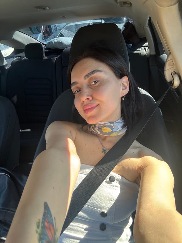 Woman takes selfies in car during early morning in Tbilisi