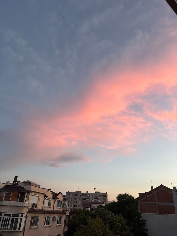 Urban rooftops under a vivid dusk sky