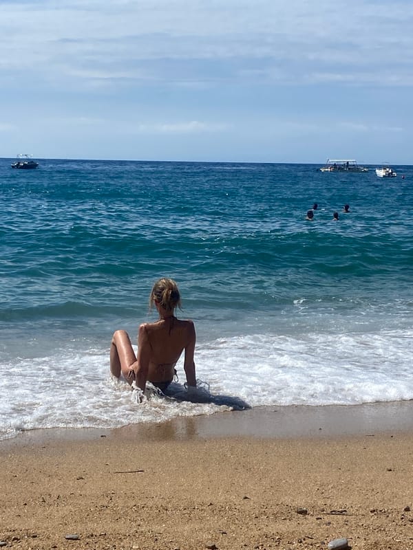 Beach visitors enjoy morning at Sveti Stefan, Montenegro