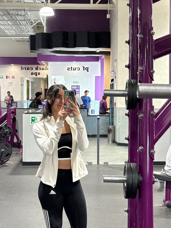 Woman takes selfie at Planet Fitness gym in Puebla