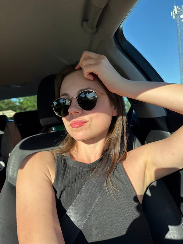 Woman poses in convertible car in Czech countryside
