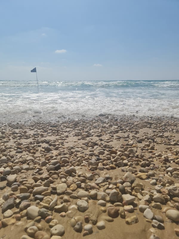 Beach scenes with sand messages and Israeli flags