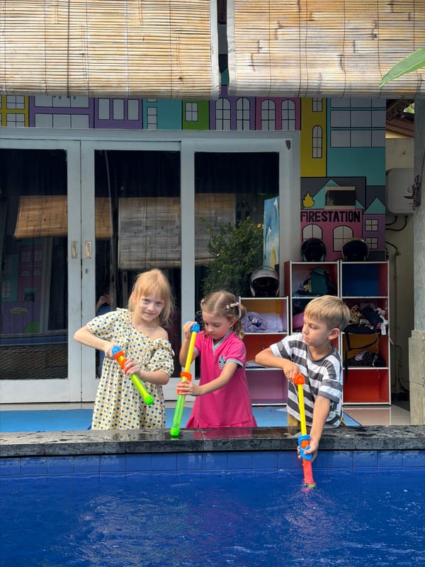 Children play with water guns at Kuta daycare facility