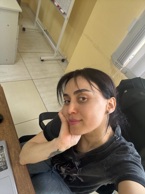 Person in contemplative pose captured indoors in Tbilisi