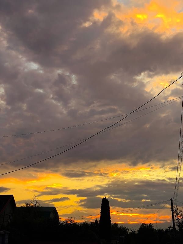 Kaliningrad sunset lights up the sky over rooftops and power lines