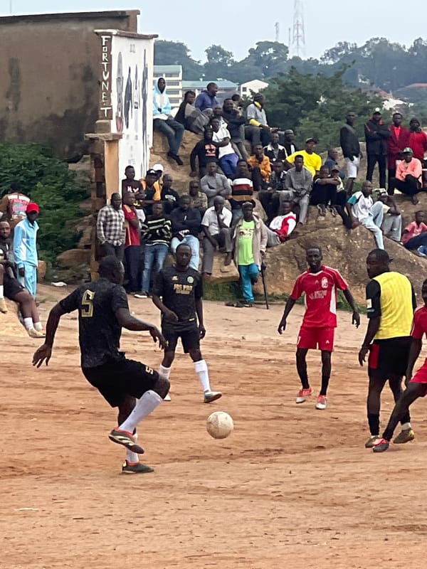 Pickup football match on a dirt pitch in Jos, Nigeria