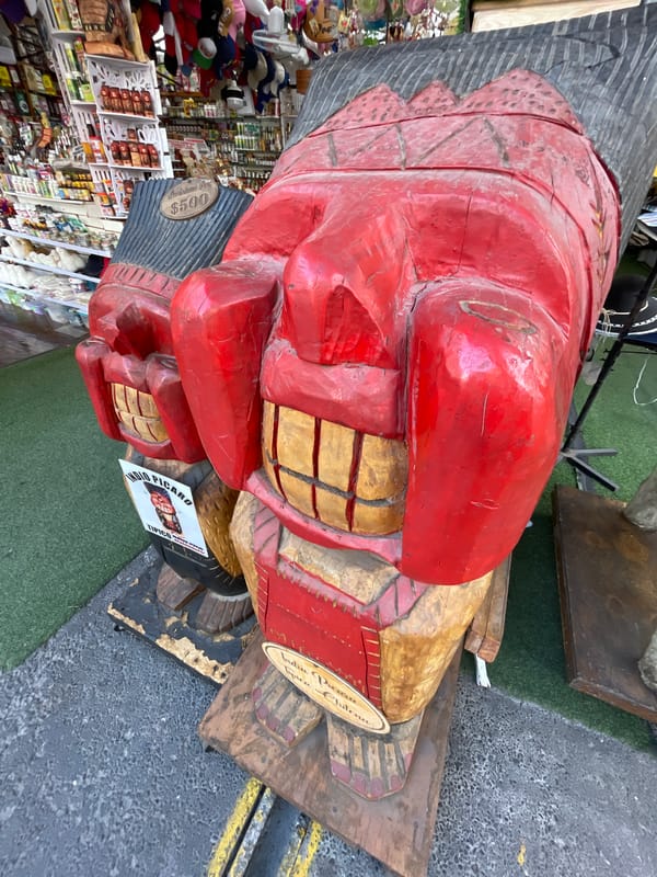Hand-carved wooden sculpture displayed at Iquique market stall