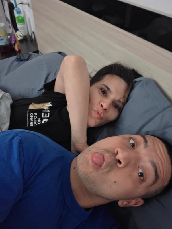 Couple poses together indoors in Veliko Tarnovo bedroom