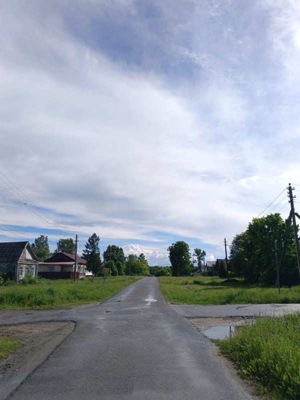 Young man poses for photos on wet road in Красный Маяк