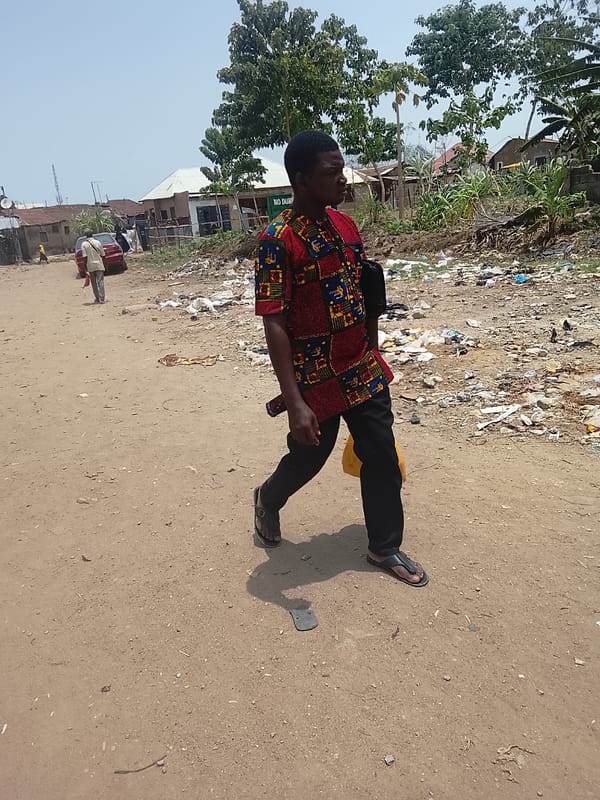 Pedestrians observed on dirt road in Abuja, Nigeria