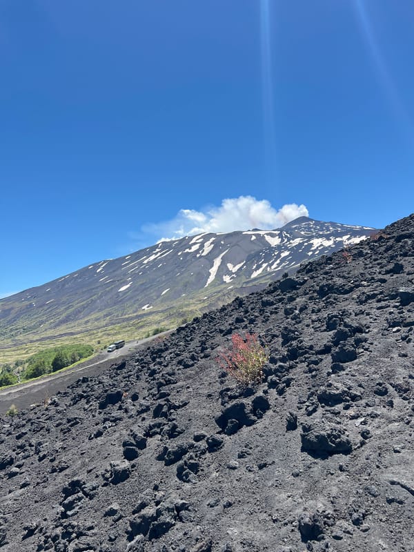 Hikers explore Mount Etna's active volcanic landscape in Sicily