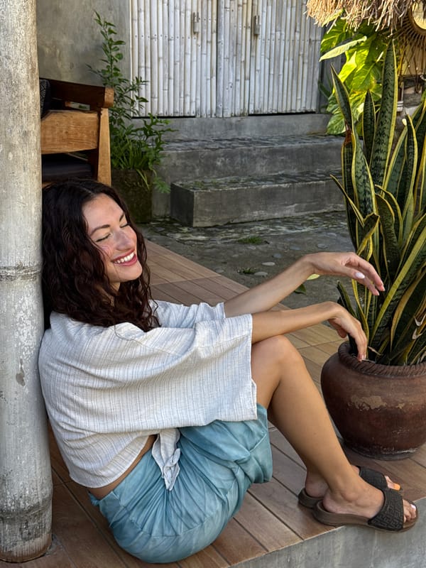 Woman rests peacefully on natural structures in North Kuta