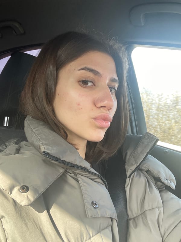 Woman poses for selfie in car passenger seat in Sofia