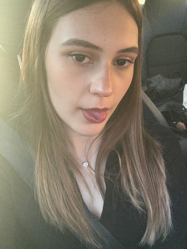 Woman photographed in car wearing silver necklace in Baden-Baden