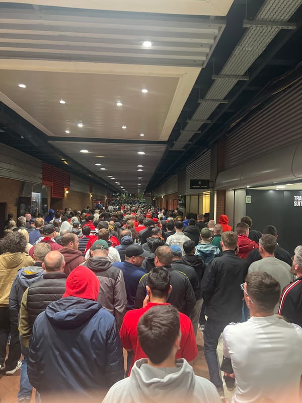 Large crowd moves through Trafford stadium concourse