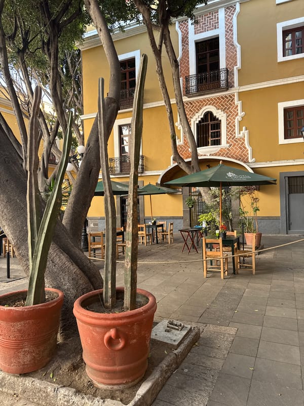 Evening street life documented around historic Puebla church