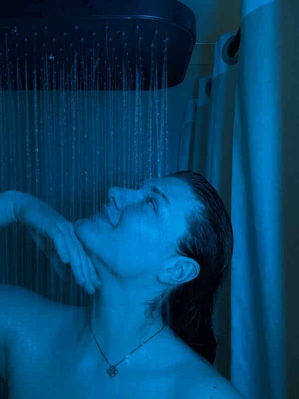 Person photographed showering under blue light in Kazan